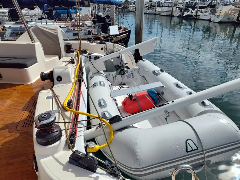 Slide: The Image of 2011 Performance Catamarans 52 with inflatable dinghy docked at marina. - 40
