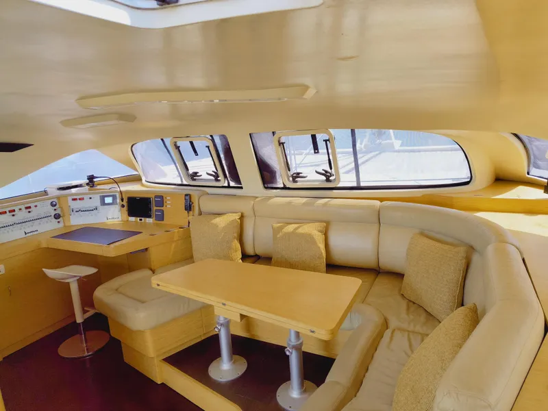 Slide: The Image of Luxurious interior of a 2011 Performance Catamarans 52, featuring a cozy seating area and navigation station. - 42