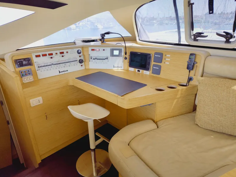 Slide: The Image of Navigation station of a 2011 Performance Catamarans 52, featuring modern controls and seating. - 44