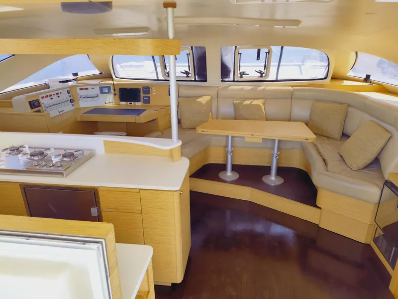 Slide: The Image of Luxurious interior of 2011 Performance Catamarans 52, featuring modern kitchen and cozy seating area. - 47