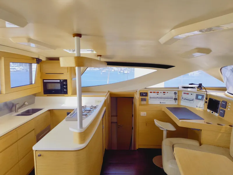 Slide: The Image of Luxurious interior of 2011 Performance Catamarans 52, featuring modern kitchen and navigation area. - 49