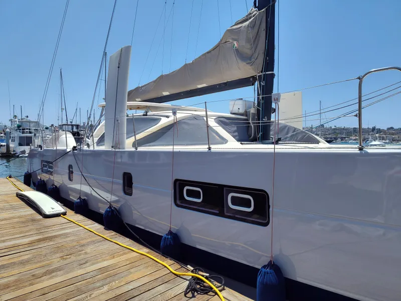 Slide: The Image of 2011 Performance Catamarans 52 docked at marina under clear blue sky. - 6