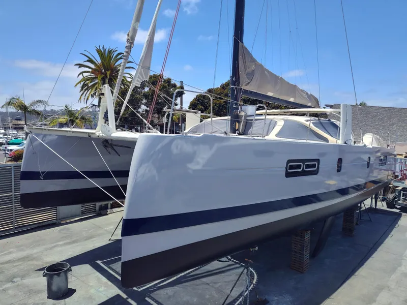 Slide: The Image of 2011 Performance Catamarans 52 on dry dock, showcasing sleek design and modern features. - 9