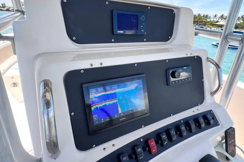Slide: The Image of 2003 Grady-White Advance 257 boat dashboard with navigation and control systems. - 3
