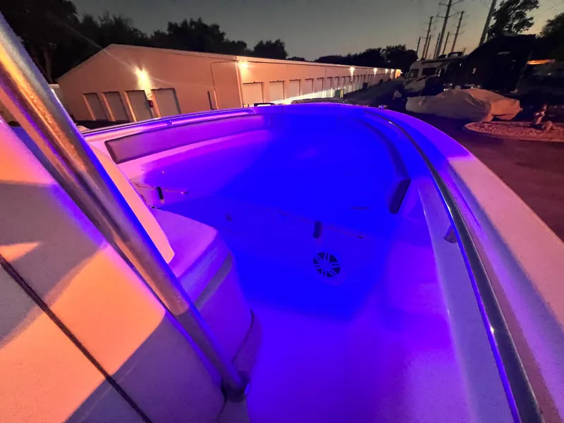Slide: The Image of 2003 Grady-White Advance 257 boat with blue interior lighting at night. - 7