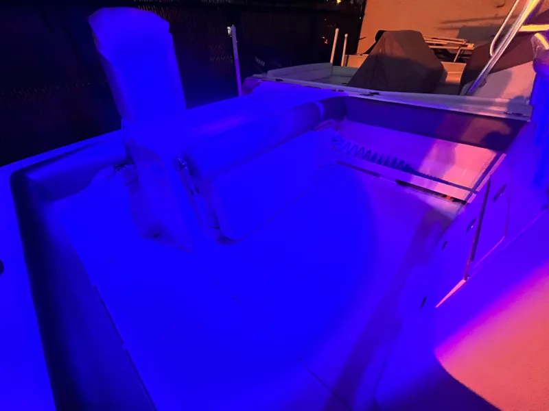 Slide: The Image of 2003 Grady-White Advance 257 boat interior illuminated by blue and purple lights. - 8
