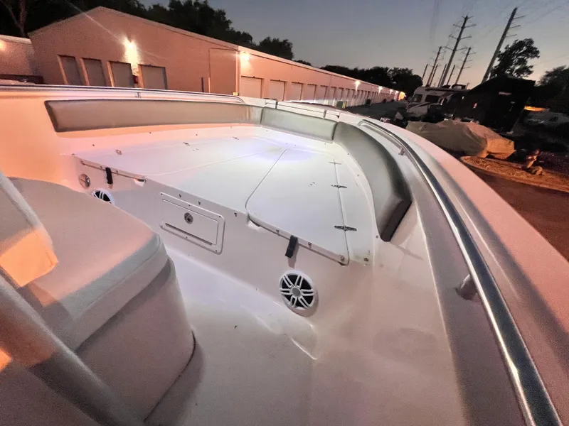 Slide: The Image of 2003 Grady-White Advance 257 boat deck at dusk, showcasing spacious seating and storage. - 9