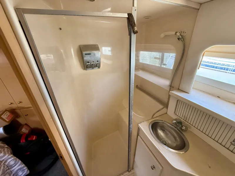 Slide: The Image of 1997 Carver 355 Aft Cabin bathroom with shower and sink. - 14