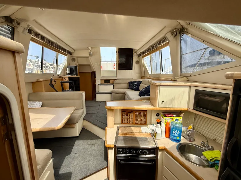 Slide: The Image of Interior of 1997 Carver 355 Aft Cabin yacht with kitchen and seating area. - 20