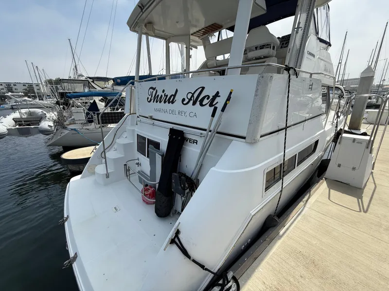 Slide: The Image of 1997 Carver 355 Aft Cabin yacht docked at marina, named "Third Act." - 3
