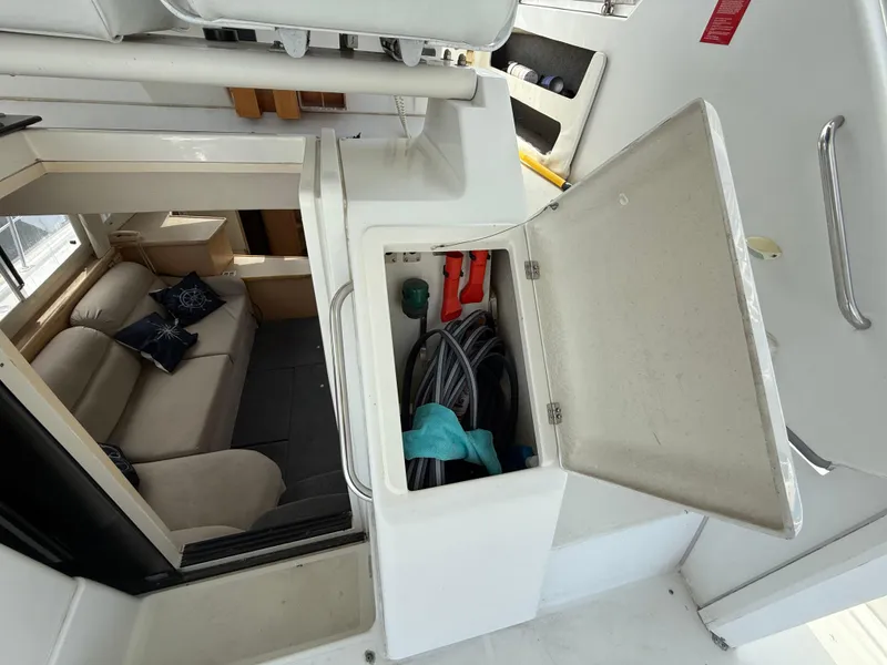 Slide: The Image of 1997 Carver 355 Aft Cabin interior with open storage compartment and cozy seating area. - 8