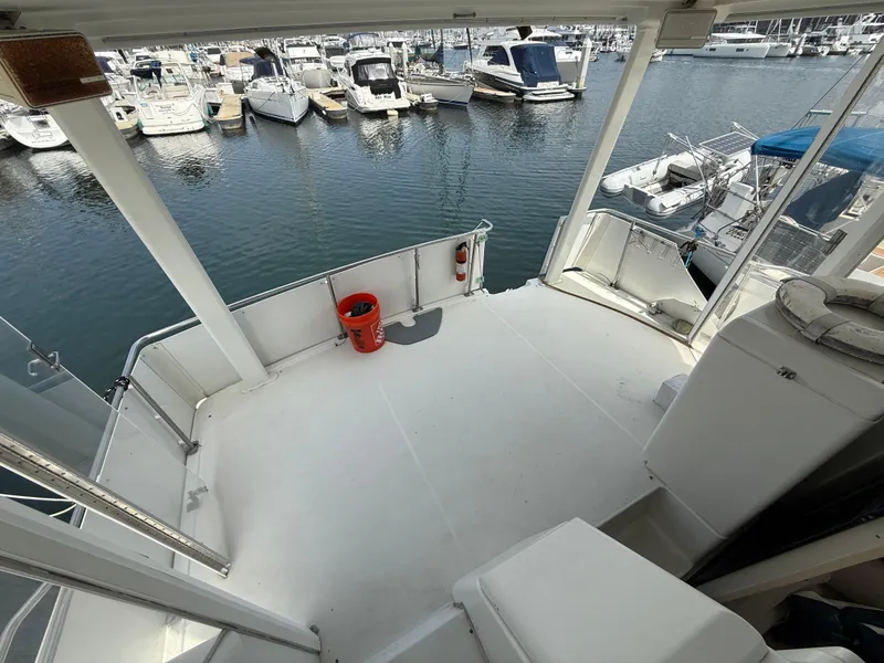 Slide: The Image of 1997 Carver 355 Aft Cabin yacht deck overlooking marina with multiple boats docked. - 9