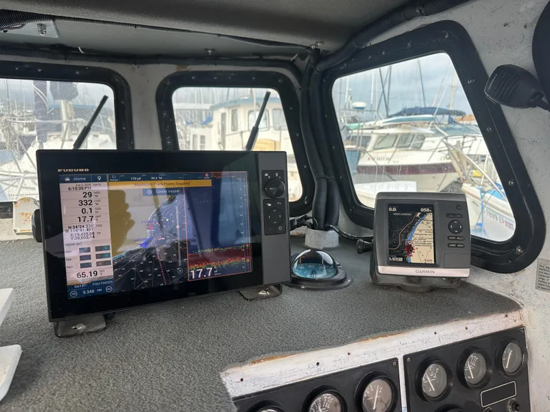 Slide: The Image of Boat dashboard with navigation screens, Radon 26, 1987 model, docked at marina. - 12