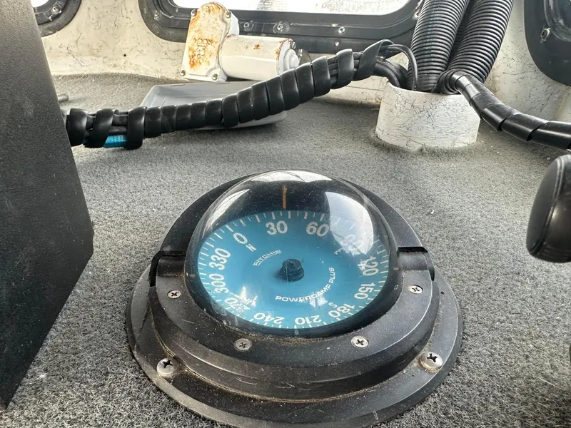 Slide: The Image of Compass on a 1987 Radon 26 boat dashboard, showing navigation details. - 17