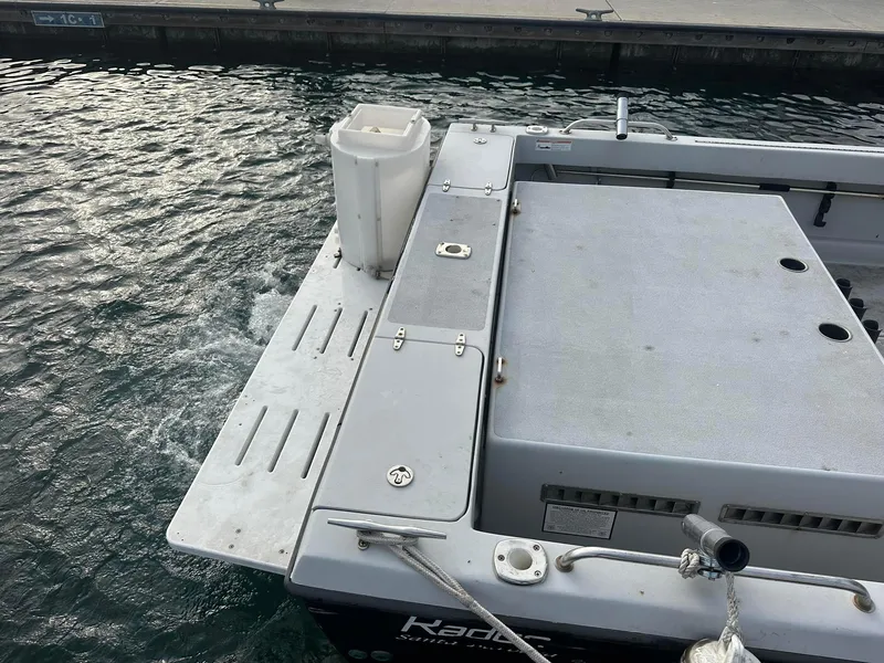 Slide: The Image of 1987 Radon 26 boat docked, showing stern and deck details. - 20