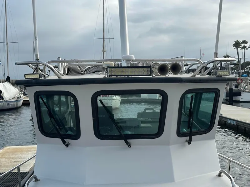 Slide: The Image of 1987 Radon 26 boat with windows and railing, docked in a marina. - 5