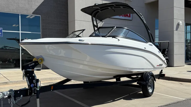 The Image of 2025 Yamaha AR195 boat on trailer, displayed outdoors near a building. - 12