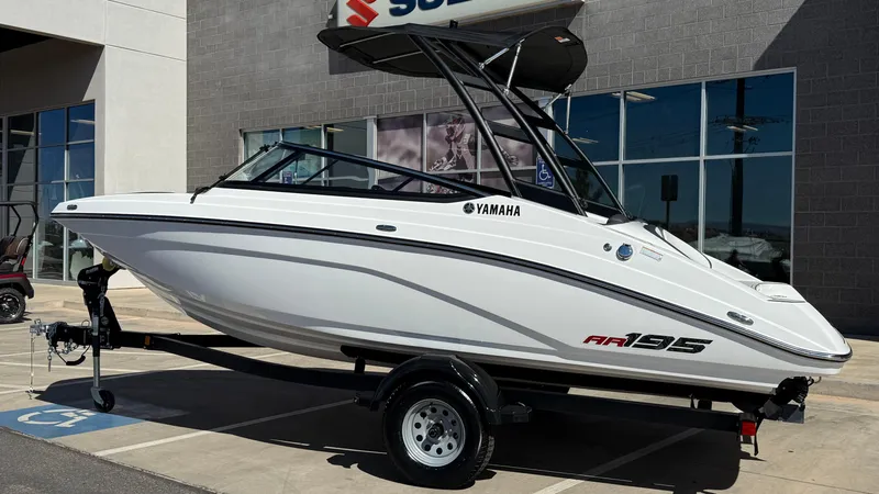 Slide: The Image of 2025 Yamaha Boats AR195 on trailer outside dealership. - 14