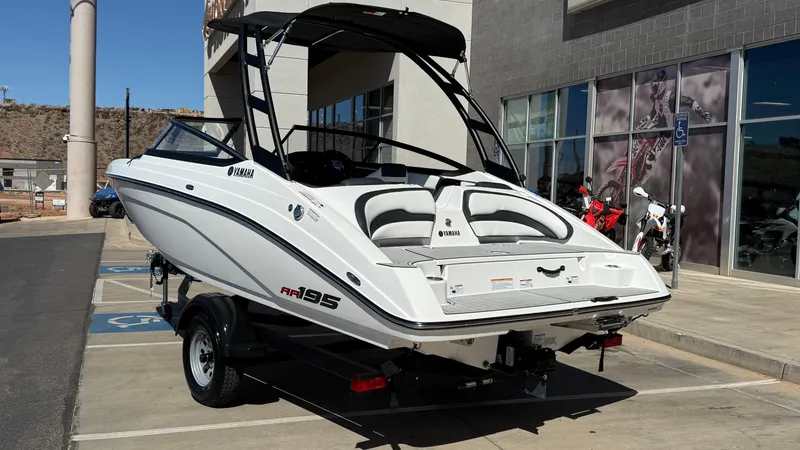 Slide: The Image of 2025 Yamaha Boats AR195 on trailer outside dealership. - 15