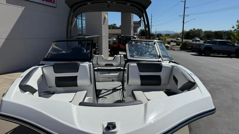 Slide: The Image of 2025 Yamaha Boats AR195 interior view at dealership, showcasing seating and dashboard. - 21