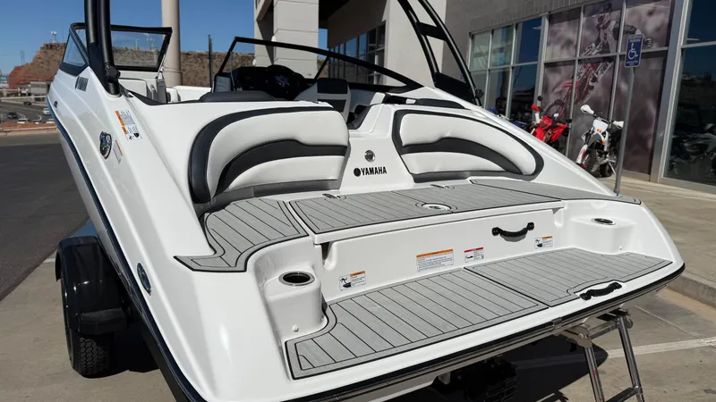 Slide: The Image of 2025 Yamaha Boats AR195, rear view, showcasing sleek design and spacious seating. - 22