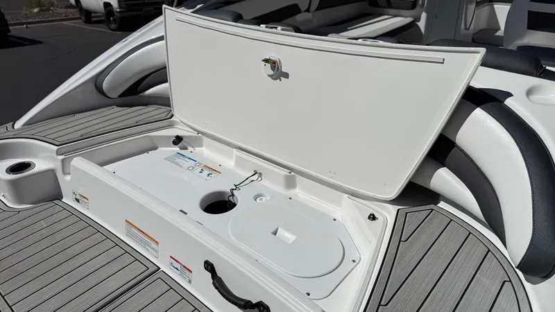 Slide: The Image of Open storage compartment on 2025 Yamaha Boats AR195, showcasing sleek design and functionality. - 23