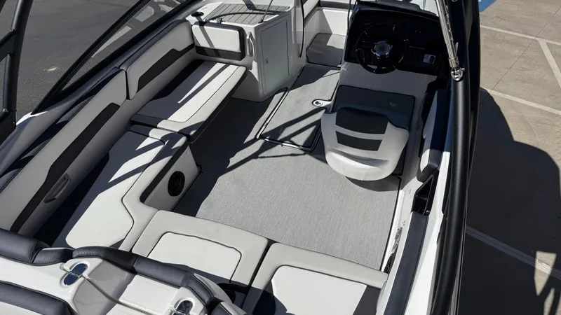 Slide: The Image of 2025 Yamaha Boats AR195 interior with sleek seating and modern dashboard design. - 25