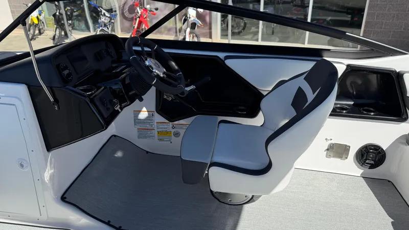 Slide: The Image of 2025 Yamaha Boats AR195 interior with steering wheel and captain's seat. - 27