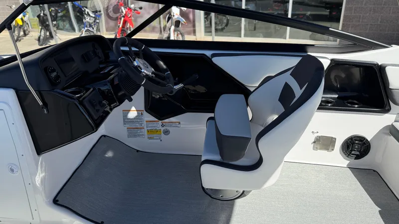Slide: The Image of 2025 Yamaha Boats AR195 interior with sleek steering and modern seating. - 28