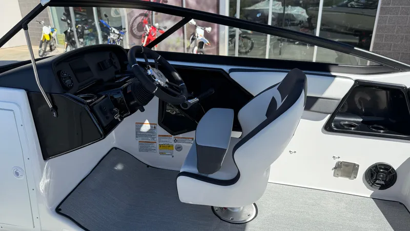 Slide: The Image of 2025 Yamaha Boats AR195 interior with steering wheel and captain's seat. - 29