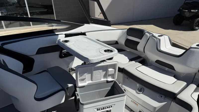 Slide: The Image of 2025 Yamaha Boats AR195 interior with seating, table, and cooler. - 31