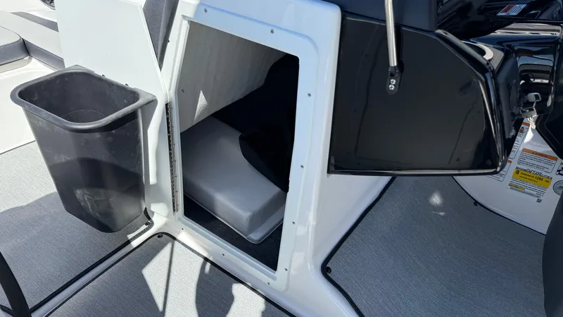 Slide: The Image of 2025 Yamaha AR195 boat interior storage compartment with trash bin. - 40
