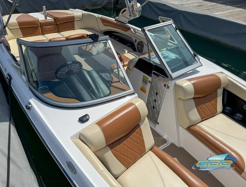 Slide: The Image of 2013 MasterCraft X-45 boat with tan and brown interior, docked at a marina. - 10
