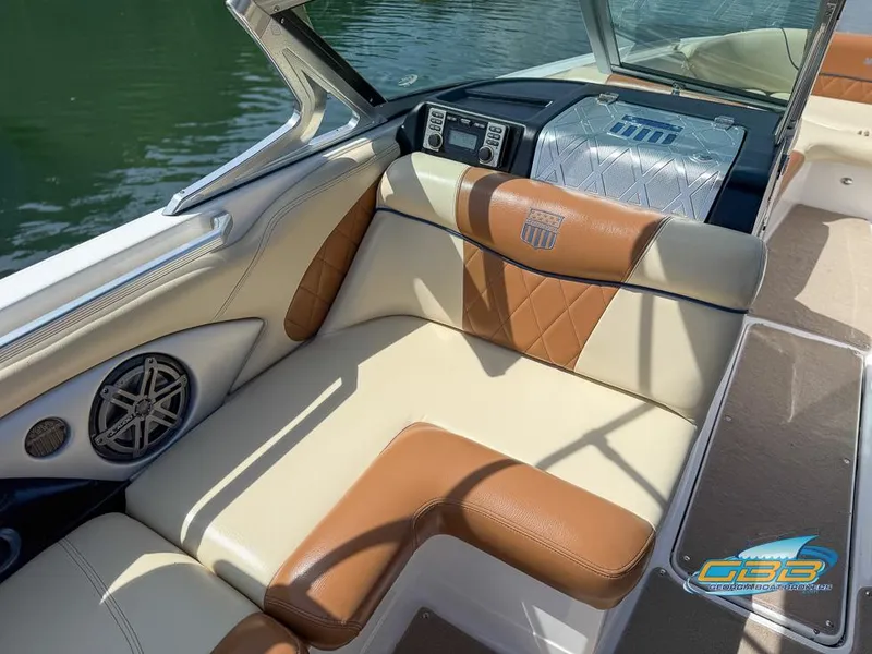 Slide: The Image of 2013 MasterCraft X-45 boat interior with tan and brown seating, featuring a sleek design. - 12
