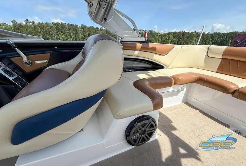 Slide: The Image of 2013 MasterCraft X-45 boat interior with beige and brown seating, featuring a speaker and control panel. - 13