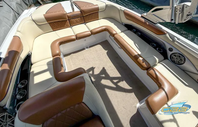 Slide: The Image of 2013 MasterCraft X-45 boat interior with brown and cream seating, spacious layout, and cup holders. - 18