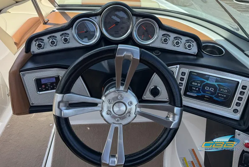 Slide: The Image of Steering wheel and dashboard of 2013 MasterCraft X-45 boat with gauges and controls. - 21