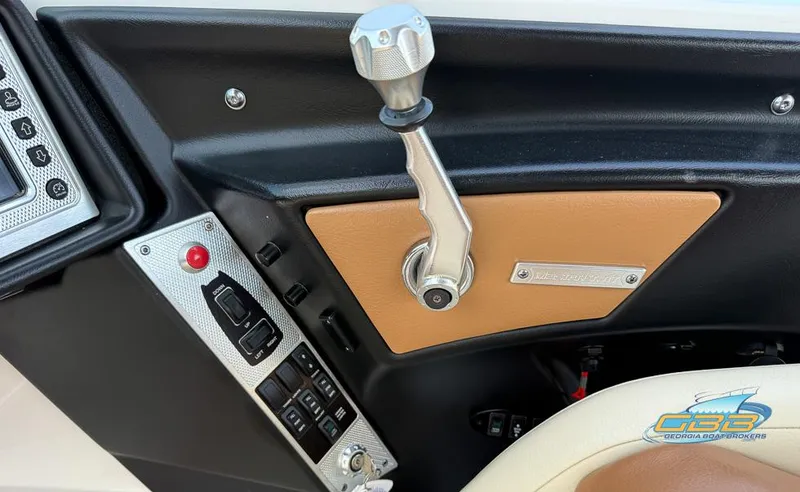 Slide: The Image of 2013 MasterCraft X-45 boat control panel with throttle lever and switches. - 25