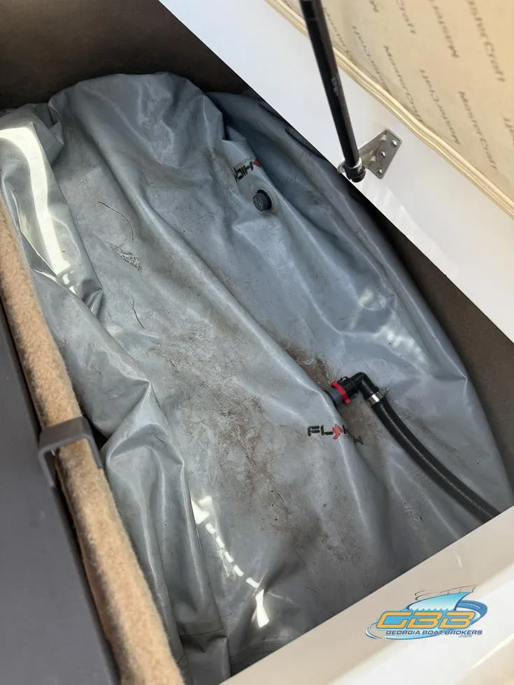 Slide: The Image of Storage compartment of a 2013 MasterCraft X-45 boat with ballast bag and hoses. - 29