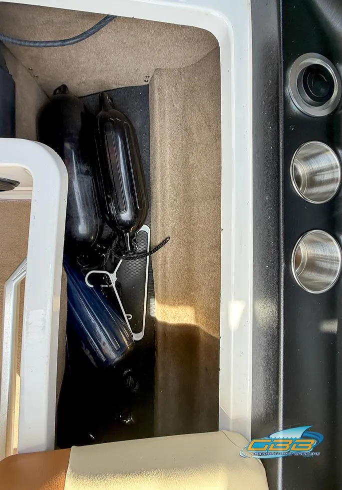 Slide: The Image of 2013 MasterCraft X-45 boat interior storage with fenders and cup holders. - 33