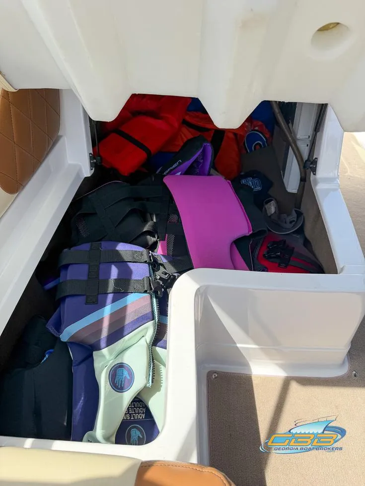 Slide: The Image of Storage compartment in a 2013 MasterCraft X-45 boat filled with colorful life jackets. - 36