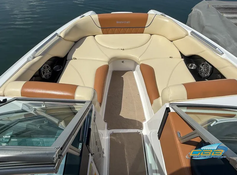 Slide: The Image of 2013 MasterCraft X-45 boat interior with tan and brown seating, open bow design. - 9