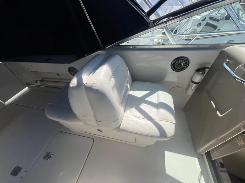 Slide: The Image of 2005 Sea Ray 290 Amberjack interior with white seating and modern design. - 11
