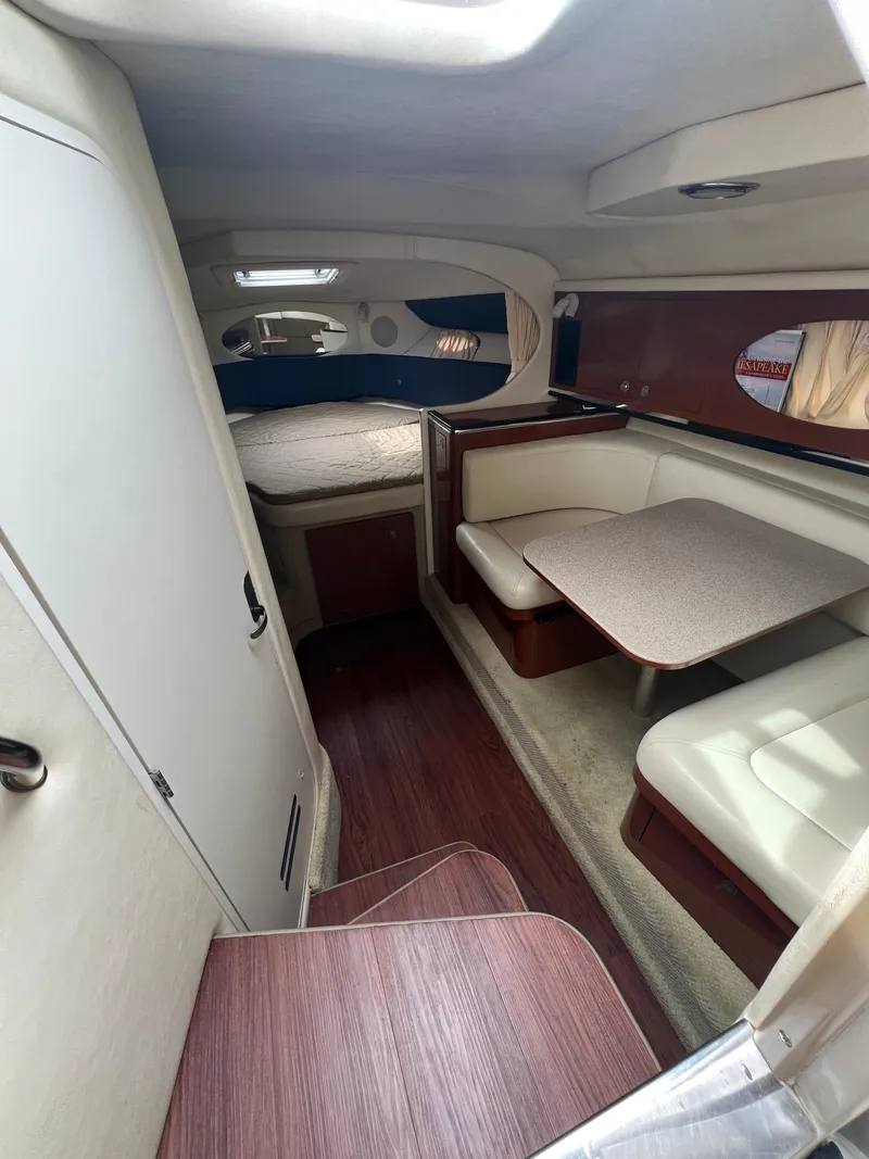 Slide: The Image of Interior of 2005 Sea Ray 290 Amberjack, featuring seating and sleeping area. - 12