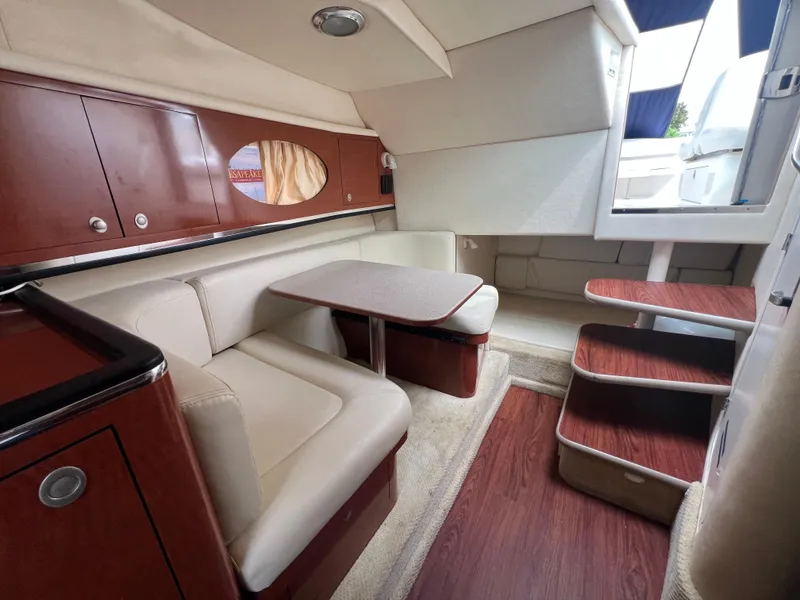Slide: The Image of Interior of 2005 Sea Ray 290 Amberjack with seating, table, and stairs. - 13