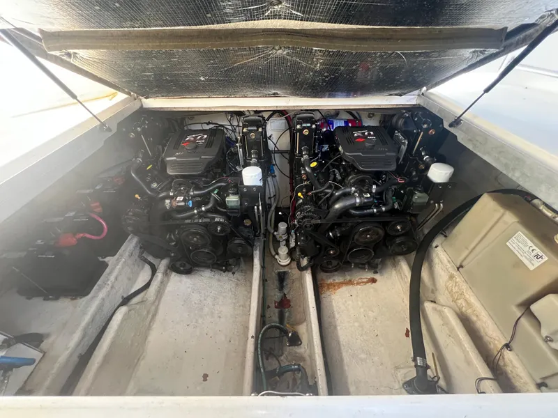 Slide: The Image of Engine compartment of a 2005 Sea Ray 290 Amberjack boat, featuring dual engines. - 18