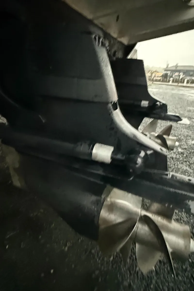 Slide: The Image of 2005 Sea Ray 290 Amberjack boat propellers on gravel surface. - 20