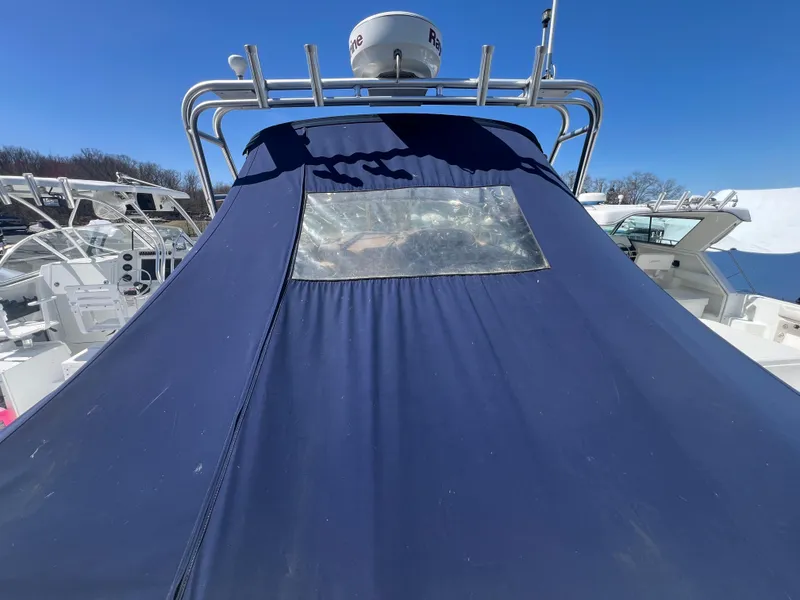 Slide: The Image of 2005 Sea Ray 290 Amberjack boat with blue canvas cover and radar equipment. - 27