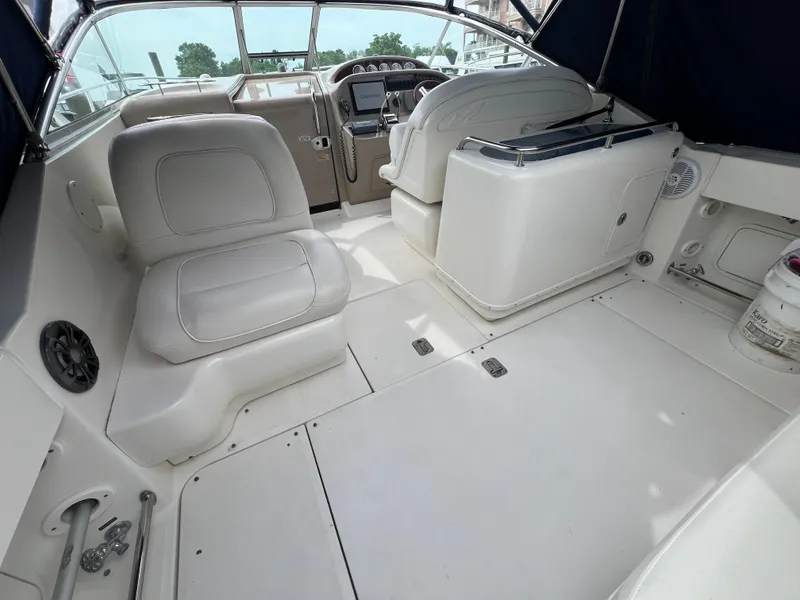 Slide: The Image of 2005 Sea Ray 290 Amberjack boat interior with white seating and helm. - 6