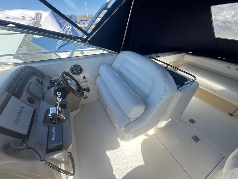 Slide: The Image of 2005 Sea Ray 290 Amberjack cockpit with white seating and navigation equipment. - 7